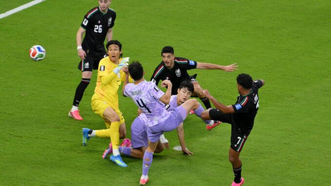 Korea and mexico players fight for the ball